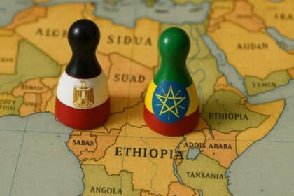Two game pieces placed on a map of Africa, one in the colors of the Egyptian flag, the other in the colors of the Ethiopian flag